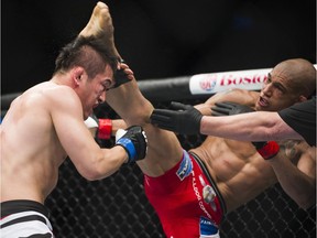 Kajan Johnson, right, kicks Tae Hyun Bang in a lightweight bout during UFC 174 in Vancouver in 2014. Johnson returns to the Octagon at UFC 215 in Edmonton on Saturday.