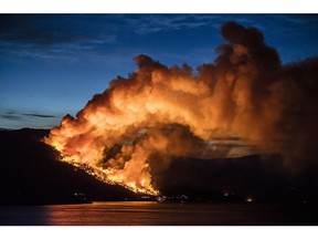 Flames from a wildfire close in on Kelowna in July, 2015.