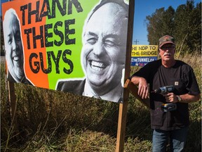 Liberal MLA Ian Paton has put up signs criticizing NDP in the fight over the Massey tunnel replacement with a bridge.