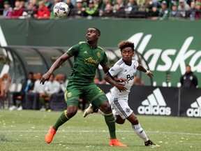 Portland Timbers defender Larrys Mabiala (33) looks to head the ball away from Vancouver Whitecaps forward Yordi Reyna.
