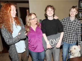 Joseph Dyer, 18, of Tecumseh, Ont., who has autism, poses with his siblings Sarah, 16, David, 14, and mother Karen Dyer in September. The next month, Joseph jumped out of his bedroom window and left the house, barefoot — but police, the community and a trucker helped bring him home.