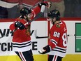 Chicago Blackhawks left wing Ryan Hartman, left, celebrates with right wing Patrick Kane after scoring a goal during the first period of an NHL hockey game against the Pittsburgh Penguins on Thursday, Oct. 5, 2017.