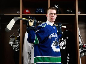 The Vancouver Canucks have signed forward Kole Lind to a three-year entry level contract.