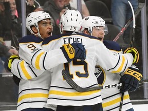 Evander Kane, left, celebrates with Buffalo Sabres teammates Jack Eichel and Sam Reinhart after Kane scored the tying goal with nine seconds left in the third period against the Vegas Golden Knights on Tuesday.