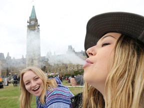 Two women smoke weed on Parliament Hill on 4/20 last year.