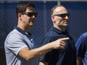 In this Feb. 24 file photo, Toronto Blue Jays general manager Ross Atkins (left) and president Mark Shapiro talk at spring training in Dunedin, Fla.