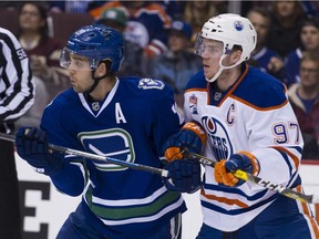 Canucks' Brandon Sutter, left, and Edmonton Oilers' Connor McDavid battle during the final NHL home game of the 2017 regular season at Rogers Arena in Vancouver on April 8.