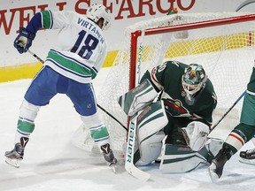 Devan Dubnyk makes a save against Jake Virtanen, who later scored the game's lone goal.