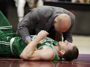 Boston Celtics' Gordon Hayward grimaces in pain in the first half of an NBA basketball game against the Cleveland Cavaliers, Tuesday, Oct. 17, 2017, in Cleveland. Just five minutes into his Boston career, new Celtics star forward Gordon Hayward gruesomely broke his left ankle, an injury that may end his season.