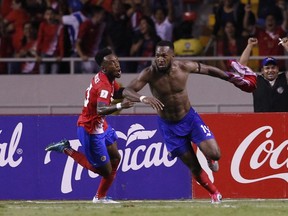 Kendall Waston, right, celebrates after scoring his team's equalizer against Honduras during a World Cup qualifying soccer match at the National Stadium in San Jose, Costa Rica.