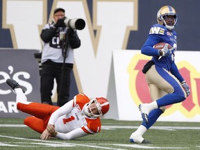 B.C. Lions kicker Ty Long can't stop Winnipeg Blue Bombers defensive back Kevin Fogg as he returns his kick for the touchdown during the first half of CFL action in Winnipeg on Saturday.