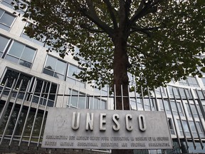 In this Monday Oct. 17, 2016 file picture, the United Nations Educational Scientific and Cultural Organization logo is pictured on the entrance at UNESCO's headquarters in Paris, France.