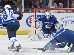 Shawn Matthias of the Winnipeg Jets takes a shot against Jacob Markstrom of the Vancouver Canucks during their NHL game at Rogers Arena October 12, 2017 in Vancouver, British Columbia, Canada.