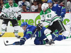 Alexander Radulov and Brandon Sutter vie for the puck on Monday night.