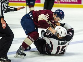 Bryan Lockner of the Regina Pats and Owen Hardy of the Vancouver Giants tussle Saturday.