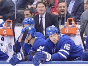 Toronto Maple Leafs head coach Mike Babcock, top, frowns as he looks on against the New Jersey Devils on Oct. 11.