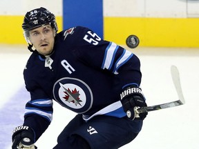 Jets' Mark Scheifele eyes the puck against the Calgary Flames during a pre-season NHL game in Winnipeg on Sept. 25.
