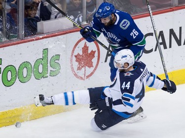 Vancouver Canucks' Thomas Vanek (26), of Austria, checks Winnipeg Jets' Josh Morrissey (44) during the second period of an NHL hockey game in Vancouver, B.C., on Thursday October 12, 2017.