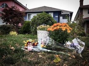 Bouquets of flowers outside a home on the 1200-block of West 64th Ave. in Vancouver where a married couple were slain on Sept. 27, 2017.