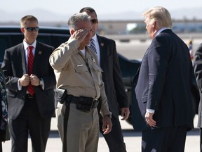 Clark County Sheriff Joseph Lombardo greets President Donald Trump after he arrived at Las Vegas McCarran International Airport to meet with victims and first responders of the mass shooting, Wednesday, Oct. 4, 2017, in Las Vegas.