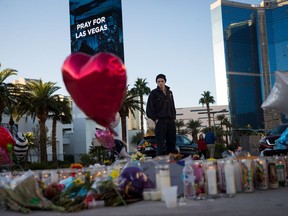 Matthew Helms, who worked as a medic the night of the shooting, visits a makeshift memorial for the victims of Sunday night's mass shooting, on the north end of the Las Vegas Strip, October 3, 2017 in Las Vegas, Nevada. The gunman, identified as Stephen Paddock, 64, of Mesquite, Nevada, allegedly opened fire from a room on the 32nd floor of the Mandalay Bay Resort and Casino on the music festival, leaving at least 58 people dead and over 500 injured. According to reports, Paddock killed himself at the scene. The massacre is one of the deadliest mass shooting events in U.S. history.