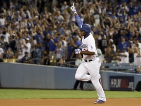 Yasiel Puig of the Dodgers celebrates his home run against the Chicago Cubs during the seventh inning of Game 1 of the National League Championship Series in Los Angeles on Saturday night