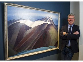 Robert Heffel poses for a photo with the Lawren Harris painting, Mountains East of Maligne Lake, at The Heffel Gallery at 2247 Granville in Vancouver. The 1925 painting carries a pre-auction estimate of $2.5 million-$3.5 million. It will be on display from Oct. 28-31 at a preview at the Heffel Gallery.