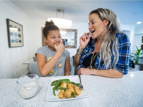 Aeryon Ashlie, with her daughter Mekaella, in their Burnaby home. The single mom struggled with bulimia for 25 years until, inspired by her daughter, she turned her life around and found balance.