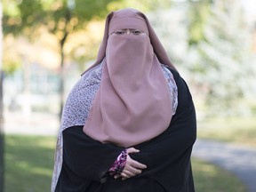 Warda Naili poses for a photograph at a park in Montreal, Saturday, October 21, 2017. Warda Naili says the first time she donned a niqab six years ago, it became a part of her. The Quebec woman, a convert to Islam, said she decided to cover her face out of a desire to practice her faith more authentically and to protect her modesty.