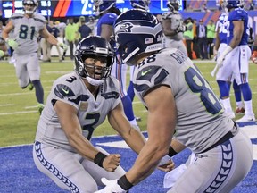 Russell Wilson, left, celebrates with Jimmy Graham after Graham caught a touchdown pass.