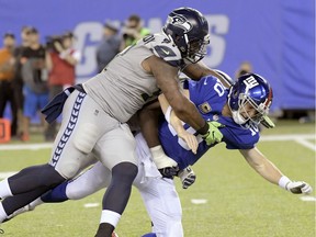 Seattle Seahawks' Sheldon Richardson, left, tackles New York Giants quarterback Eli Manning during the second half of an NFL football game, Sunday, Oct. 22, 2017, in East Rutherford, N.J.