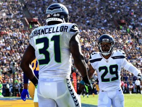 Kam Chancellor celebrates a broken pass play with Earl Thomas of the Seattle Seahawks against the Los Angeles Rams.