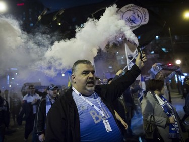 Vancouver Whitecaps supporters march to B.C. Place stadium for the team's MLS playoff soccer game against the San Jose Earthquakes in Vancouver, B.C., on Wednesday October 25, 2017.