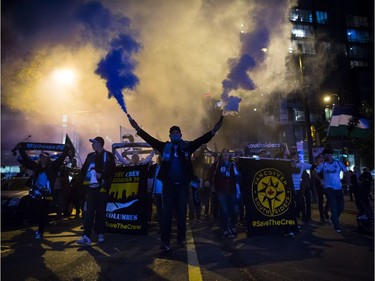 Vancouver Whitecaps supporters march to B.C. Place stadium for the team's MLS playoff soccer game against the San Jose Earthquakes in Vancouver, B.C., on Wednesday October 25, 2017.