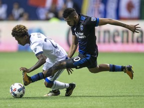 Vancouver Whitecaps' Yordy Reyna, left, and San Jose Earthquakes' Jahmir Hyka vie for the ball during the second half of an MLS playoff soccer game in Vancouver, B.C., on Wednesday October 25, 2017.