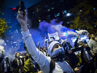 Vancouver Whitecaps supporters march to B.C. Place stadium for the team's MLS playoff soccer game against the San Jose Earthquakes in Vancouver, B.C., on Wednesday October 25, 2017.