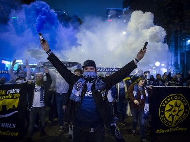 Whitecaps supporters march to B.C. Place stadium for the team's MLS playoff soccer game against the San Jose Earthquakes.