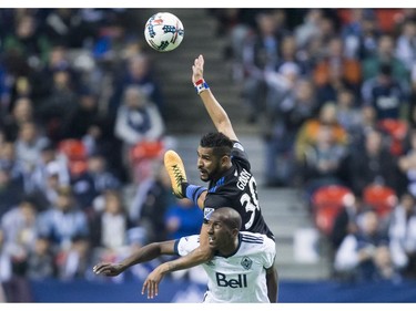 San Jose Earthquakes' Anibal Godoy, top, and Vancouver Whitecaps' Aly Ghazal vie for the ball during the first half of an MLS playoff soccer game in Vancouver, B.C., on Wednesday October 25, 2017.