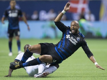 San Jose Earthquakes' Victor Bernardez, front, reacts as he falls to the ground after Vancouver Whitecaps' Aly Ghazal, back, took the ball away from him during the first half of an MLS playoff soccer game in Vancouver, B.C., on Wednesday October 25, 2017.