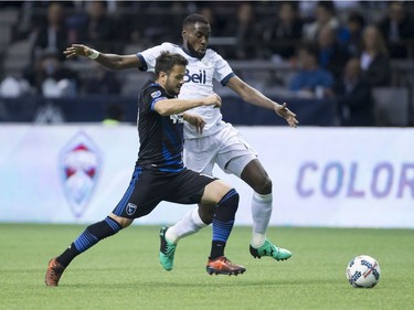 San Jose Earthquakes' Vako Qazaishvili, front, and Vancouver Whitecaps' Tony Tchani vie for the ball during the first half of an MLS playoff soccer game in Vancouver, B.C., on Wednesday October 25, 2017.