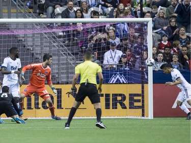 Vancouver Whitecaps' Fredy Montero, right, uses his head to score a goal against San Jose Earthquakes' goalkeeper Andrew Tarbell (28) during the first half of an MLS playoff soccer game in Vancouver, B.C., on Wednesday October 25, 2017.