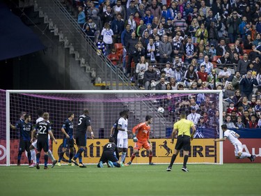 Vancouver Whitecaps' Fredy Montero, right, uses his head to score a goal against San Jose Earthquakes' goalkeeper Andrew Tarbell, third right, during the first half of an MLS playoff soccer game in Vancouver, B.C., on Wednesday October 25, 2017.