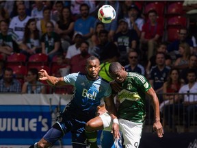 Portland Timbers' Fanendo Adi and Vancouver Whitecaps ' Kendall Waston go head-to-head during a 2016 game at B.C. Place.