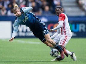Brek Shea, left, gets tripped up as he and San Jose Earthquakes' Kofi Sarkodie vie for the ball during the first half.