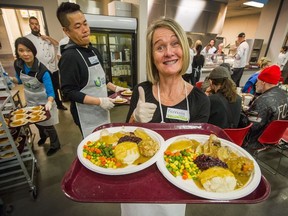 Fionnuala Brady hands out Thanksgiving meals at the DTES Union Gospel Mission in Vancouver on Oct. 9. Charities and non-profit groups will face a cash crunch in the coming years as donations don't keep up with demand.