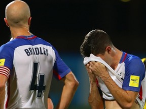 Michael Bradley (L) and Christian Pulisic (R) of the United States mens national team react to their loss against Trinidad and Tobago during the FIFA World Cup Qualifier match between Trinidad and Tobago at the Ato Boldon Stadium on October 10, 2017 in Couva, Trinidad And Tobago.