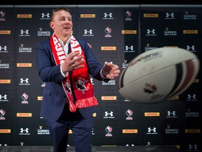 Rugby Canada men's national team Head Coach Kingsley Jones passes a ball while posing for a photograph after he was introduced as the new coach of the team, in Vancouver, B.C., on Tuesday October 24, 2017. THE CANADIAN PRESS/Darryl Dyck