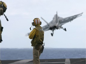 A US F-18 fighter plane takes off from the deck of USS Kitty Hawk (CV63) aircraft carrier in the Bay of Bengal, during the Malabar exercise.