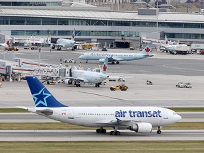 An Air Transat plane sits on the tarmac at Toronto's Lester B. Pearson Airport, Thursday October 21, 2010.