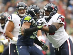 Defensive end Dwight Freeney of the Seattle Seahawks blocks tackle Duane Brown of the Houston Texans during the first quarter of the game at CenturyLink Field on Sunday in Seattle. On Monday, Brown was traded to the Seahawks.